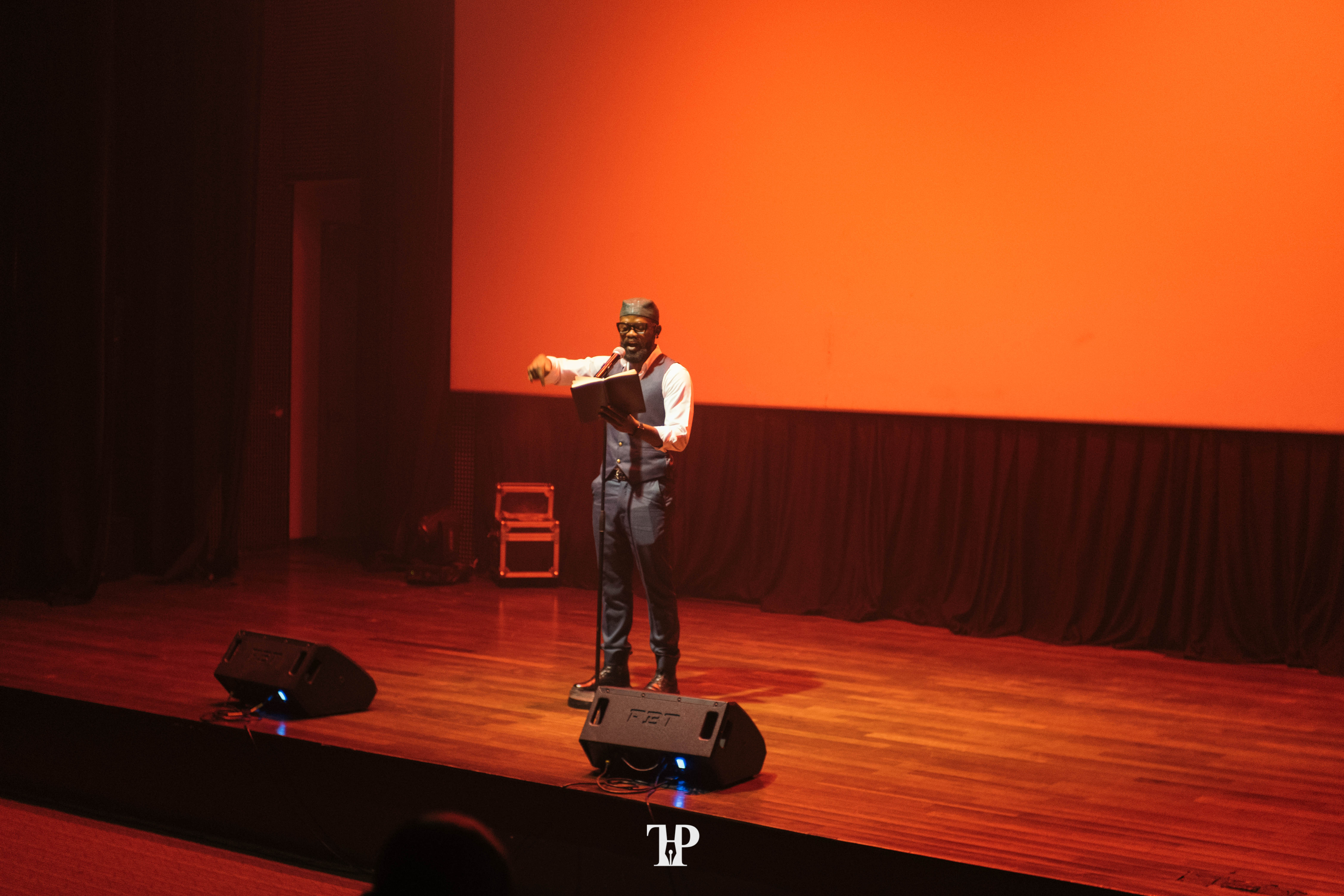 Spoken-word performance on the Alliance Française stage at Nezer House of Magic